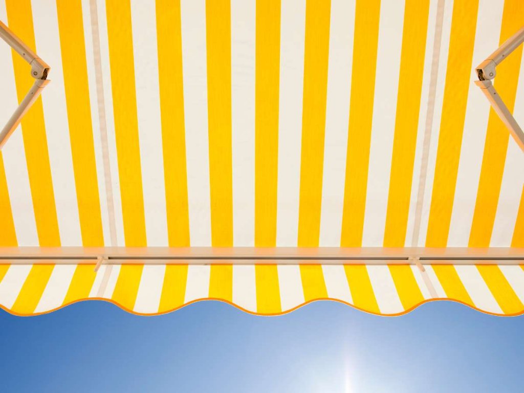 Striped awning above a door, adding a playful and colorful touch to the entrance.
